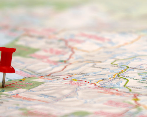 A map with a pinpoint with a hyper localized position to signify location based marketing